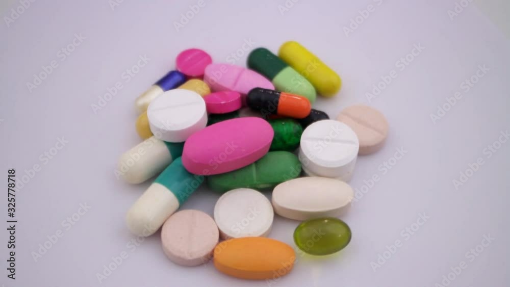 Heap of colorful pills and drugs rotating Heap of colorful pills and drugs rotating