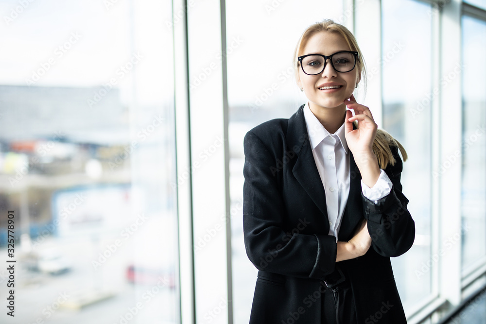 New day new decisions. Young beautiful woman holding hand on chin and looking thoughtful while sitting at her working place New day new decisions. Young beautiful woman holding hand on chin and looking thoughtful while sitting at her working place