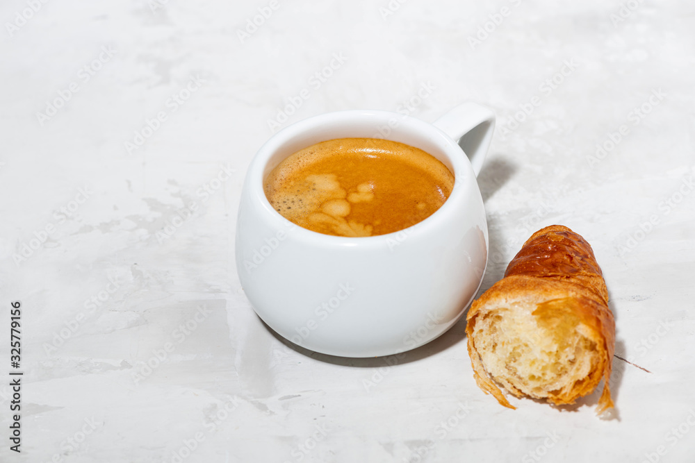 cup of espresso and fresh croissants on white background cup of espresso and fresh croissants on white background