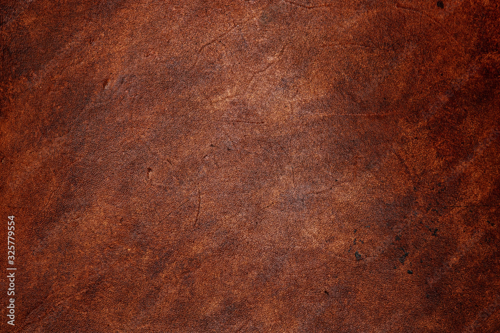 Dark brown vegetable tanned leather closeup, showing full frame grain texture Dark brown vegetable tanned leather closeup, showing full frame grain texture