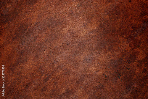 Dark brown vegetable tanned leather closeup, showing full frame grain texture