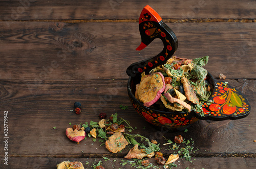 dried fruits in wooden painted swan-like dish photo