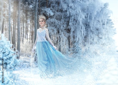 Fototapeta Beautiful snow princess in winter forest Snow queen