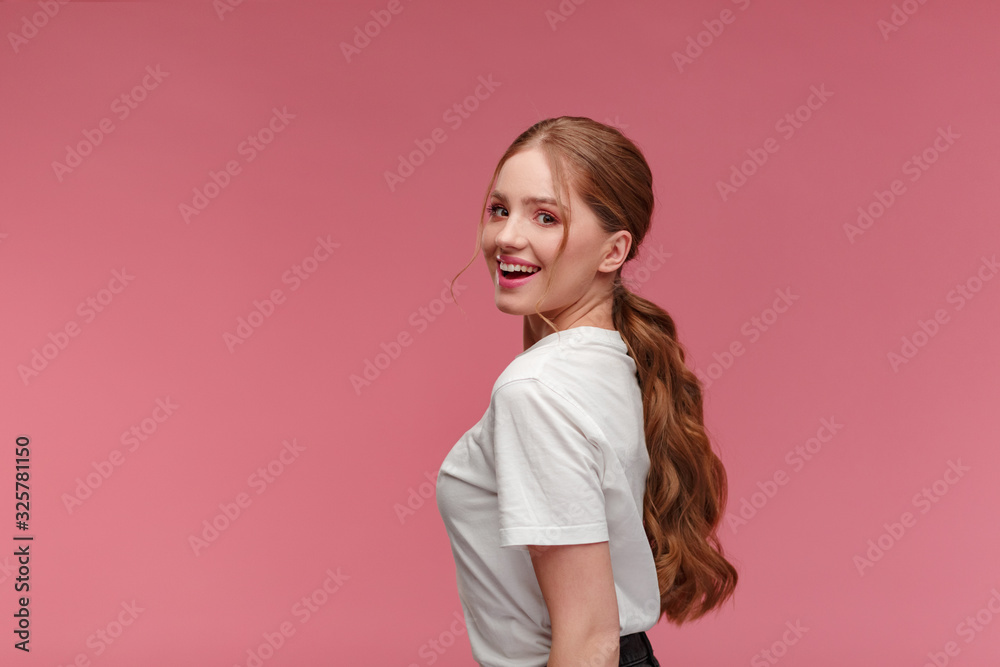Beauty portrait of smiling redhead girl. Perfect skin. Beautiful female model with long hair over pink background. Young cute woman with clear skin. Skincare and facial treatment concept. Beauty portrait of smiling redhead girl. Perfect skin. Beautiful female model with long hair over pink background. Young cute woman with clear skin. Skincare and facial treatment concept.