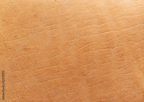 Natural vegetable tanned leather closeup macro full frame texture showing top grain and scratch wear marks