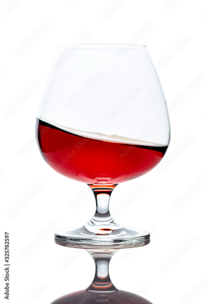 Splash of cognac in glass, isolated on white. Splash of cognac in glass, isolated on white.