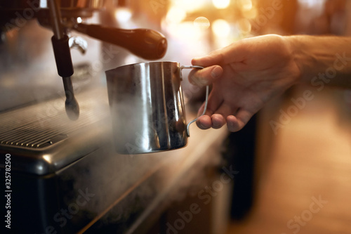 man preparing coffee on steam espresso working machine, close up side view photo.Step by step skills of coffee making
