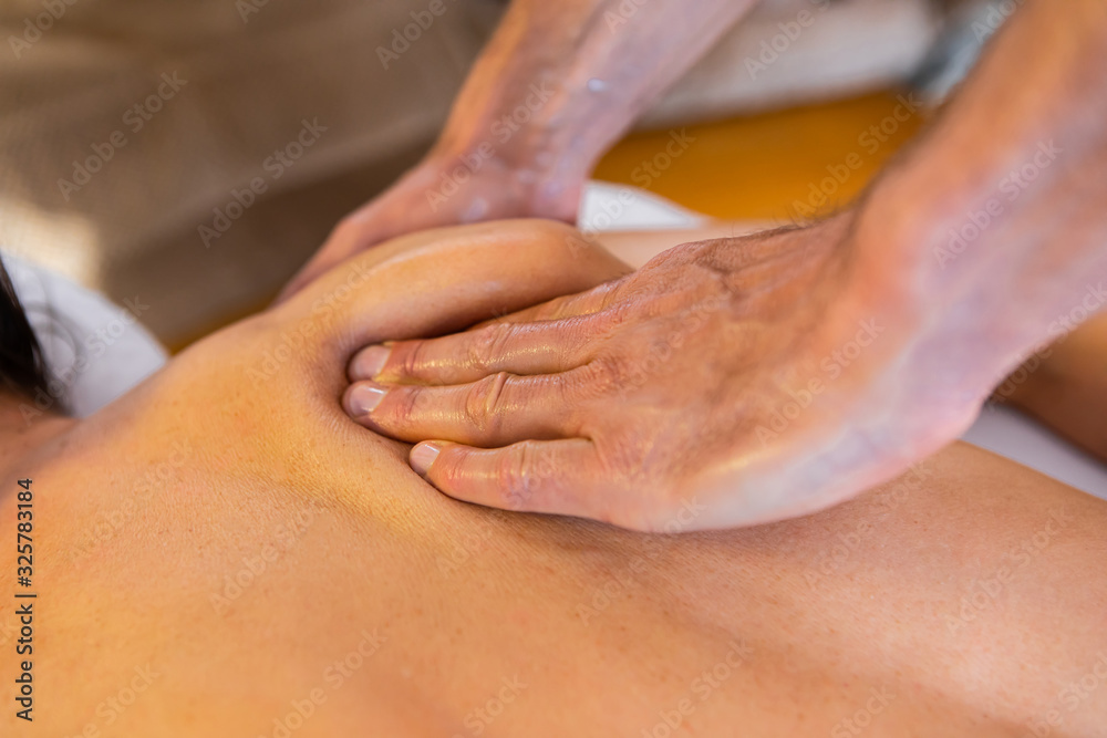 © Valmedia - Close-up view of professional masseur-therapist hands giving massage. Young woman receiving a massage in a cosy home environment © Valmedia - Close-up view of professional masseur-therapist hands giving massage. Young woman receiving a massage in a cosy home environment
