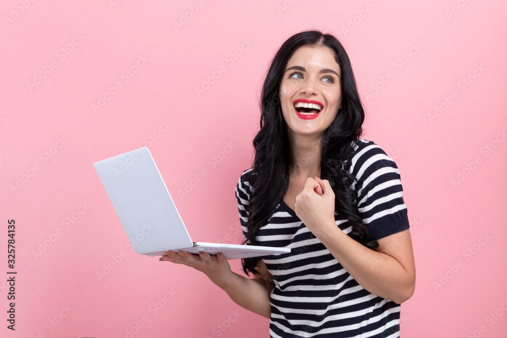Young woman with a laptop computer with successful pose Young woman with a laptop computer with successful pose