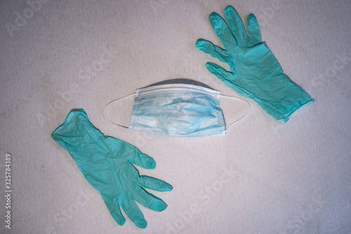 Blue surgical mask and gloves background. Medicine, healthcare and dentistry. Infection and spread protection and prevention. Coronavirus COVID-19 outbreak.