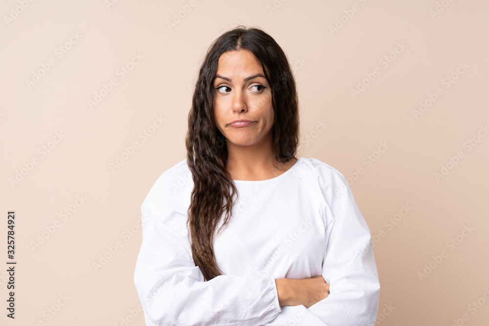 Young woman over isolated background thinking an idea Young woman over isolated background thinking an idea