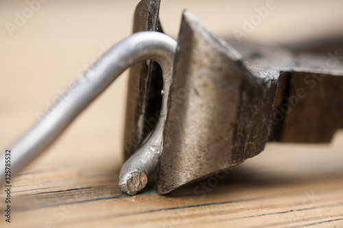 Old iron nippers on wood background