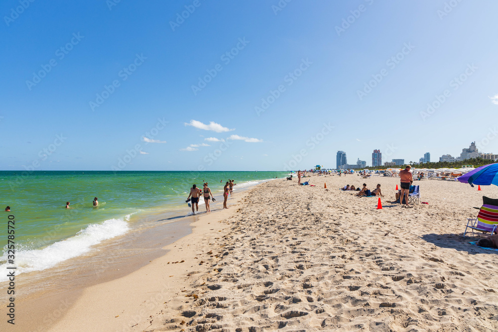 Beautiful landscape view of Miami South  Beach coast line. Sand beach, Atlantic Ocean, people  on blue sky background. USA. Miami Beach. 