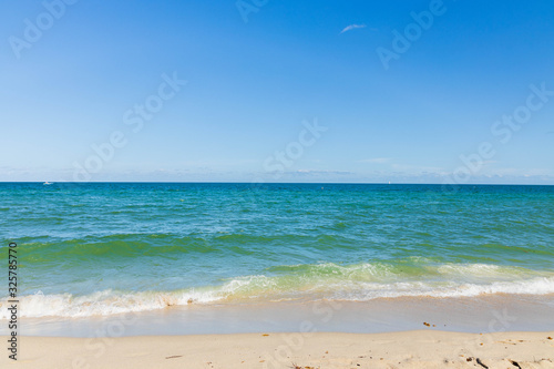 Amazing view of turquoise water of Atlantic ocean and blue sky with white clouds. Miami Beach. Beautiful nature background.