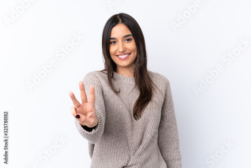 Young brunette woman over isolated white background happy and counting three with fingers