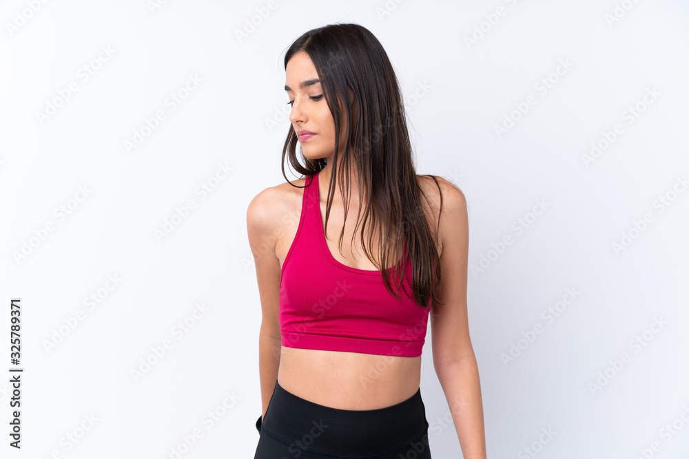 Young sport brunette woman over isolated white background stretching leg Young sport brunette woman over isolated white background stretching leg