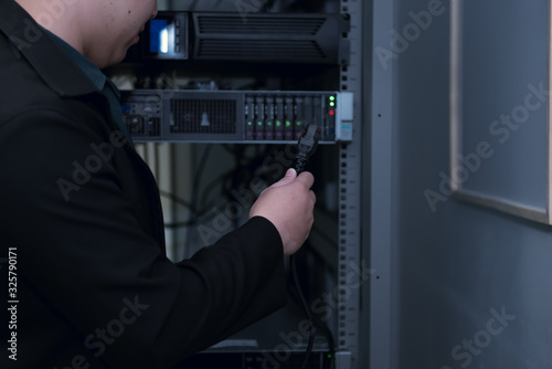 Engineer with toolboxs come to server room for work,check problem of network,repair server in the server room,thailand people,asian man