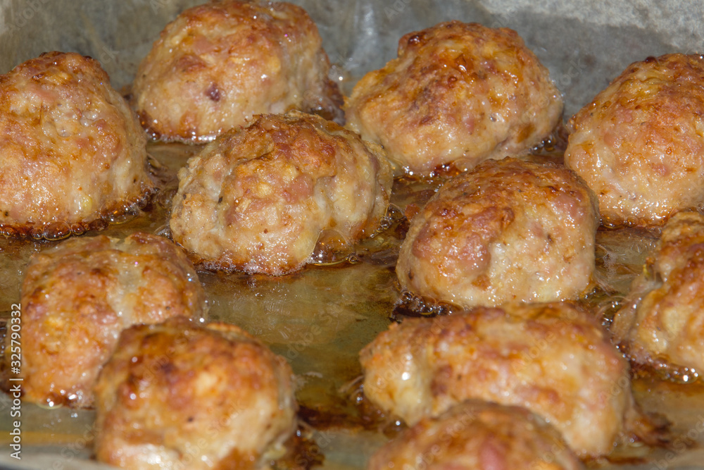 Homemade meat cutlets with a delicious golden crust are fried in oil in the oven.