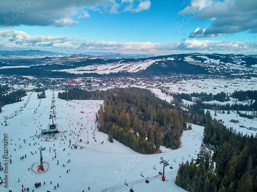 Beautiful panoramic aerial drone view to the ski slopes with lifts in the Bialka Tatrzanska ski resort Tatra Mountains (Tatras, Tatra) - mountain range between Slovakia and Poland photo