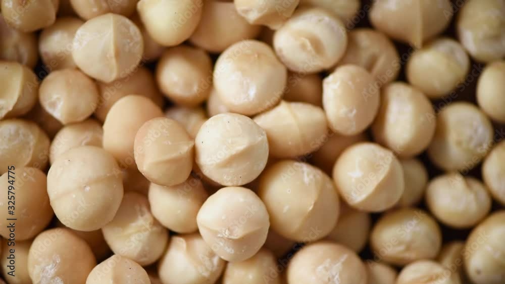 Macadamia nuts rotation. Food ingredient background. Vegan, vegetarian diet. Healthy lifestyle. Natural dry fruits and nuts concept product.