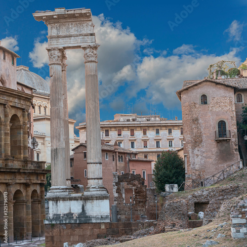 Antique columns of the forum of Julius Caesar on a sunny summer day against the blue sky. Rome. Italy