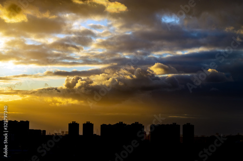 thunderclouds at sunset against the backdrop of urban development