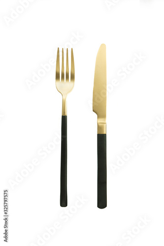 Black golden cutlery view from above on a white background. Top view. Knife and fork for a festive table for a wedding, birthday or party.