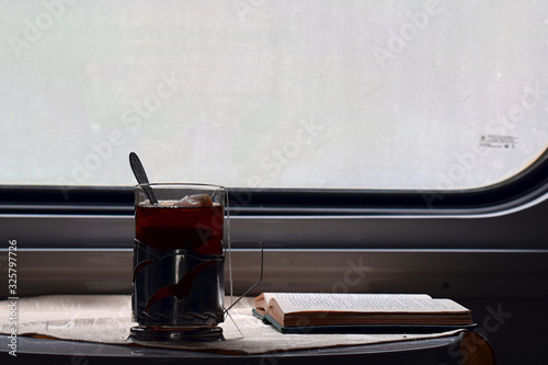 A glass of tea, a gadget and glasses in the car photo