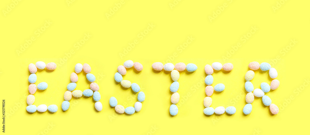 Easter.Text on a yellow background from colorful eggs, handmade banner,holidays background