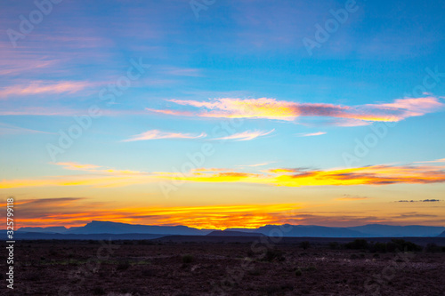 Yellow clouds and blue mountains at sunset in the Karoo