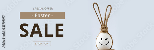 Easter sale banner with easter egg and rabbit ears.