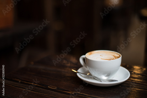 Cup of coffee latte on old wooden background