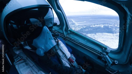 A helmeted pilot makes a landing