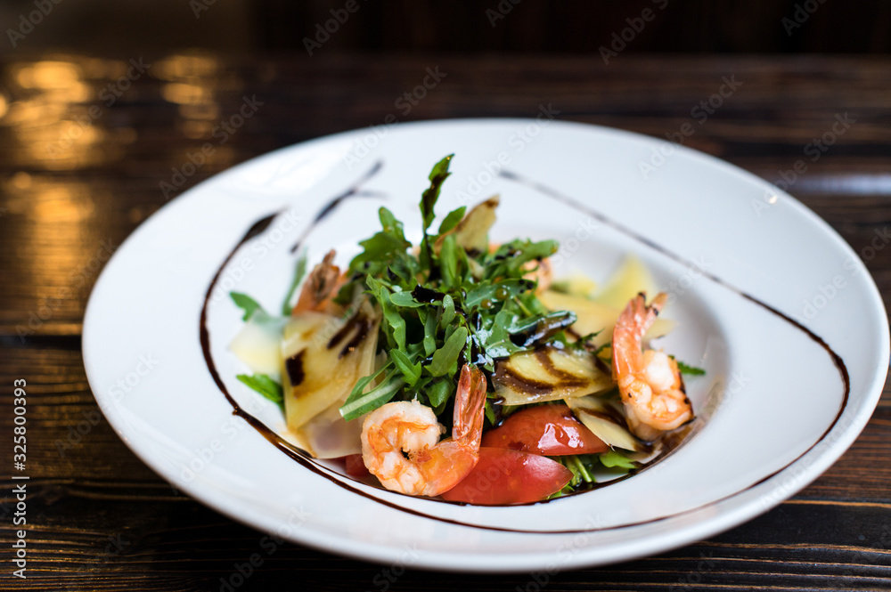 Grilled shrimps and fresh green salad served for lunch Grilled shrimps and fresh green salad served for lunch
