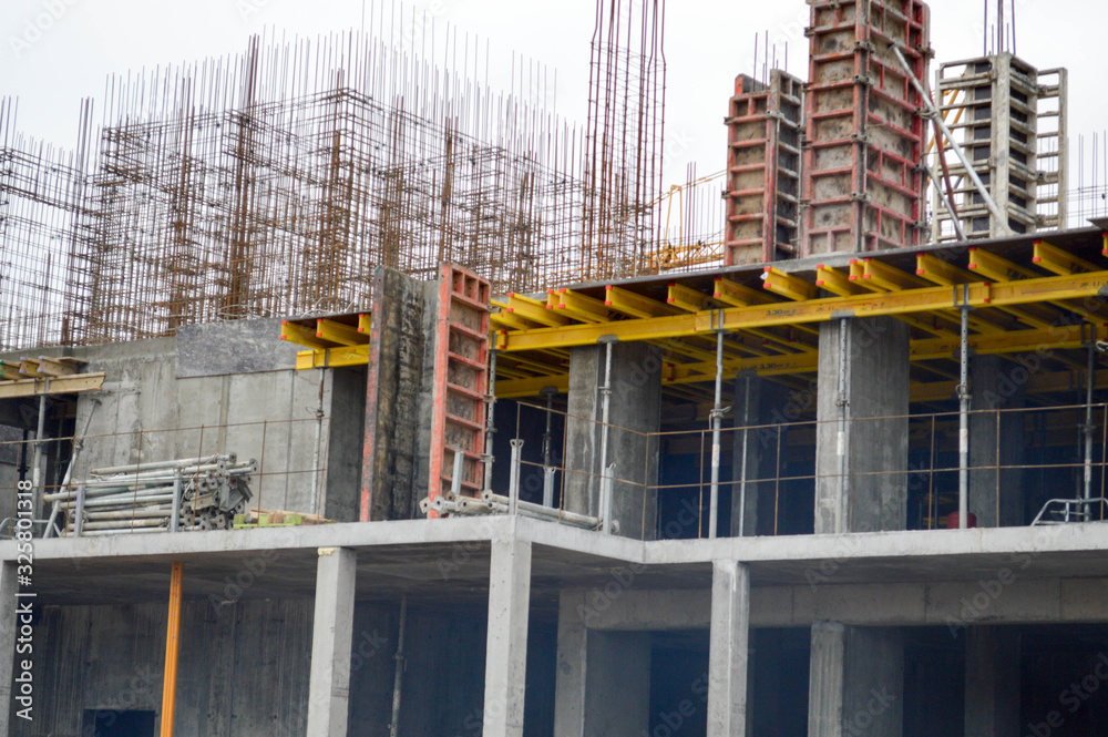 The process of construction and repair of a new modern cement concrete stone pannel monolithic frame-block building of a house with iron reinforcement at an industrial construction site