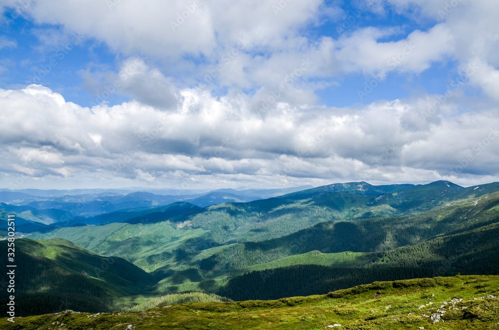 Picturesque Carpathian mountains landscape, view from the height.Mountain range Chornohora with its spurs in the Carpathian Mountains in summer. View from the top of mount Pip Ivan, Ukraine