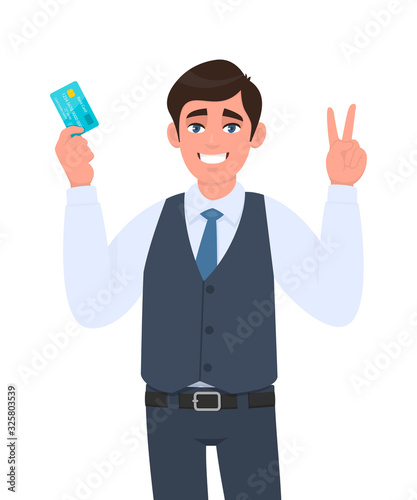Young businessman showing credit, debit card. Man making or gesturing victory, V, peace or two sign. Trendy person in waistcoat holding ATM card. Stylish male character illustration in vector cartoon.