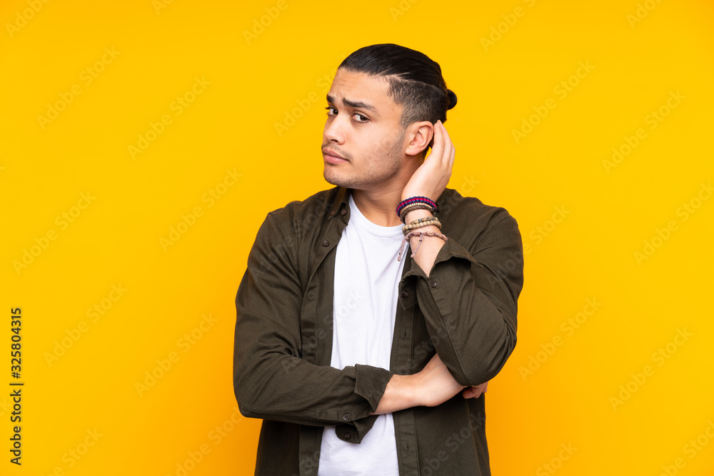 Asian handsome man isolated on yellow background happy and smiling Asian handsome man isolated on yellow background happy and smiling