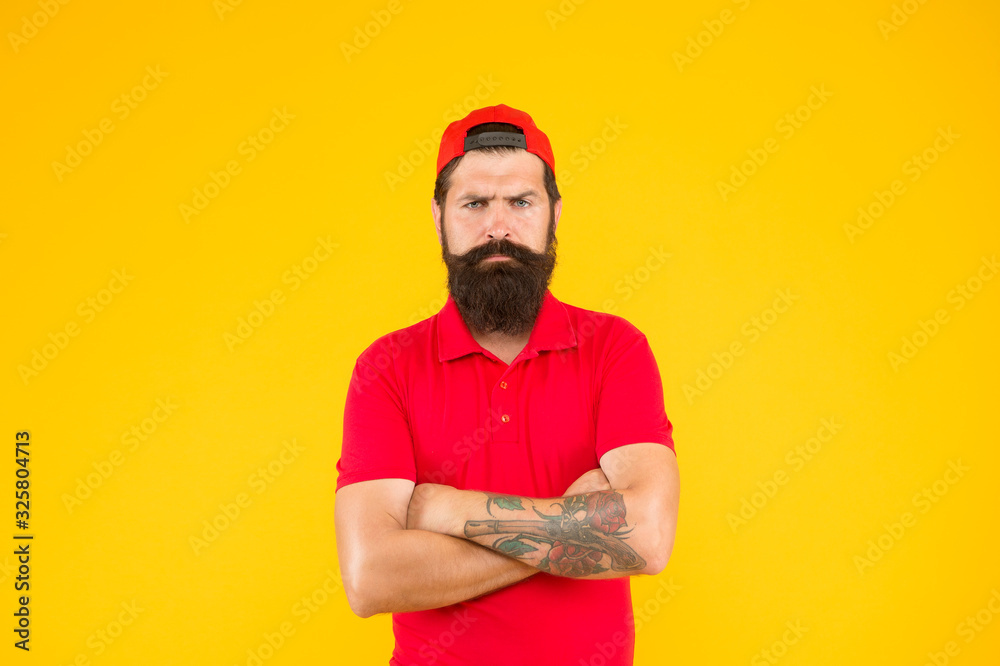 Hipster life. Brutal handsome hipster tattooed man. Bearded man trendy style. Beard and mustache grooming. Cool hipster with beard wear stylish cap. Barber salon and facial hair care. Masculinity