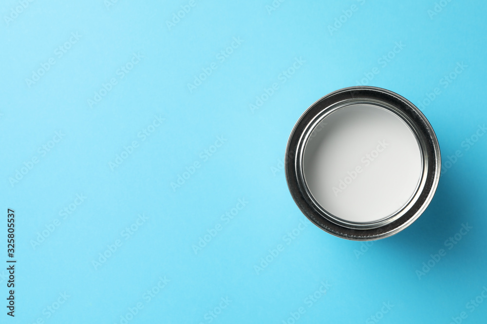 Paint can on blue background, top view