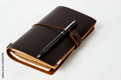 Business contact book and pen, close-up