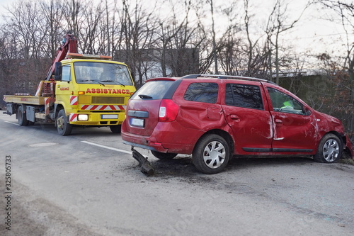 Assistance car lifts and loads a car after an accident. Tow truck with equipped hydraulic manipulator.   ar accident concept.