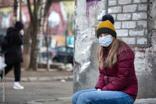 Sick woman wearing surgical face mask on a street