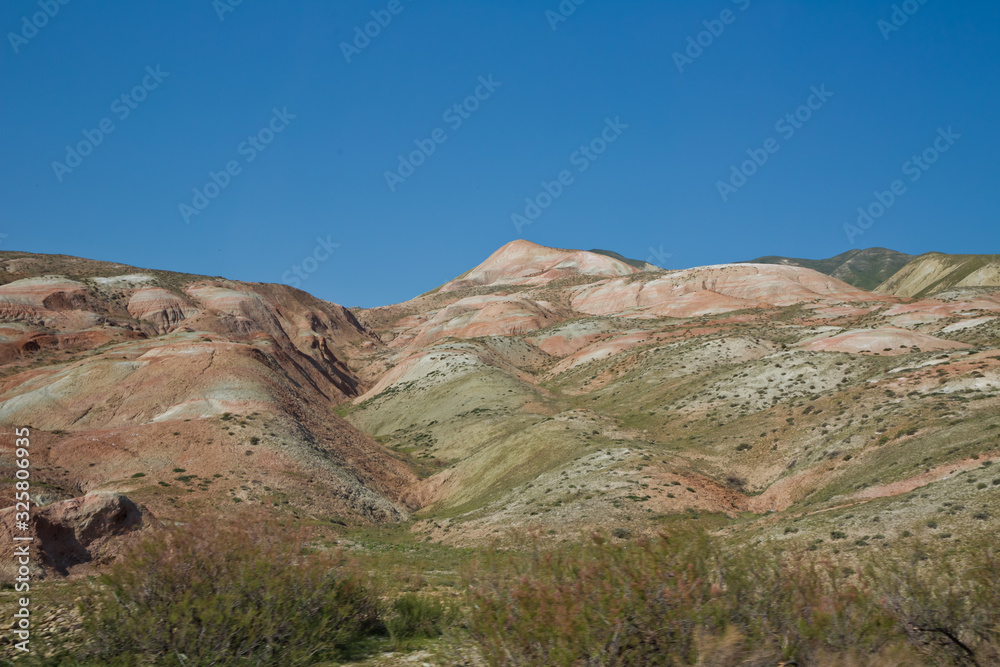 Red mountains in Xizi, Azerbaijan. Colorful hills . olorful geological formations . Red striped hills, rainbow mountains . View of the beautiful striped red mountain .