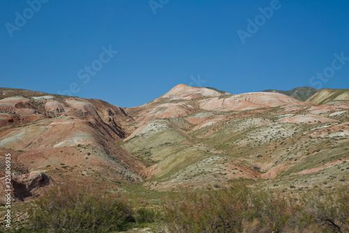 Fototapeta Naklejka Na Ścianę i Meble -  Red mountains in Xizi, Azerbaijan. Colorful hills . olorful geological formations . Red striped hills, rainbow mountains . View of the beautiful striped red mountain .