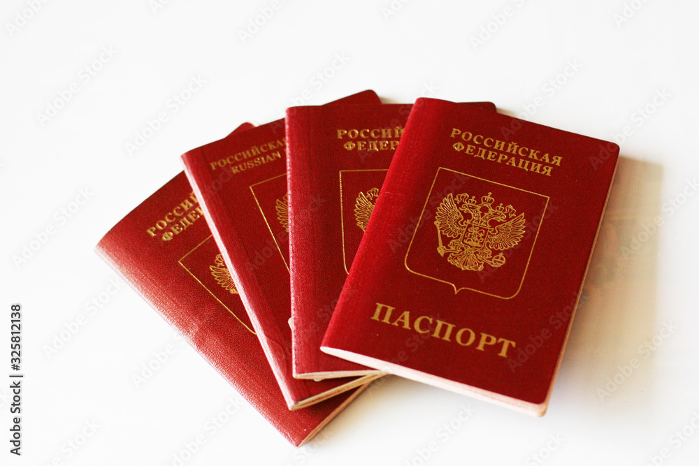 Four russian foreign passport on a white background. Dark red passport cover with copy space Four russian foreign passport on a white background. Dark red passport cover with copy space