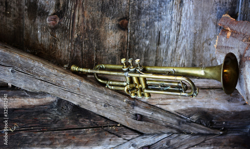an old jazz trumpet in an old farm photo