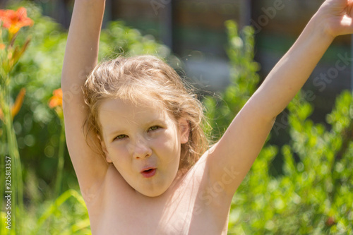 The child raises his hands in a joyful outburst.
