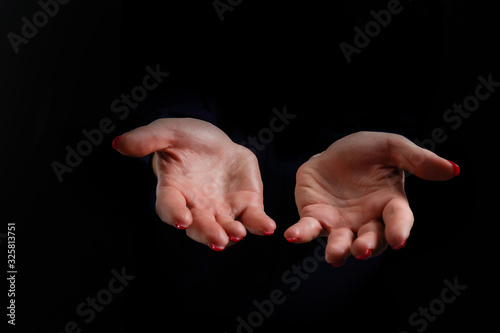 Praying hands on black background