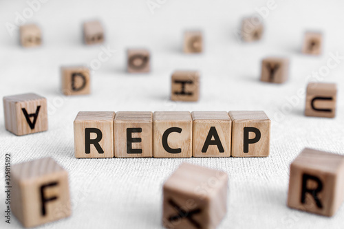 RECAP - words from wooden blocks with letters, a summary of what has been said; a recapitulation RECAP concept, white background photo